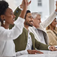 People raising their hands to participate together