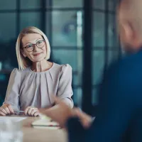 A woman listens to someone talking to her