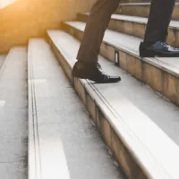 legs walking up concrete stairs