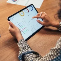 businesswoman analyzing data on tablet