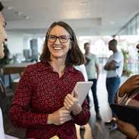 three people at work smiling