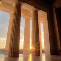 View from inside a courthouse looking out during a sunrise