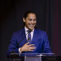 smiling man in blue suit at podium