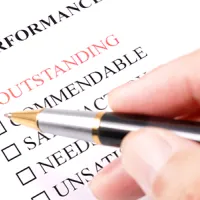 hand holding pen to do performance evaluation