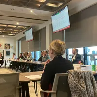 people in conference room watching presentation