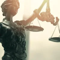 close up of metal lady justice holding scales