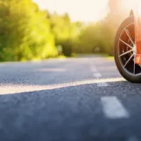 red car on asphalt road in summer