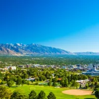 aerial view of city on sunny day with mountains in the background
