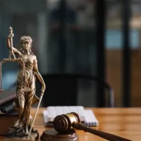 statue of lady justice on desk of judge or lawyer