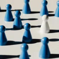 white pawn amid blue pawns