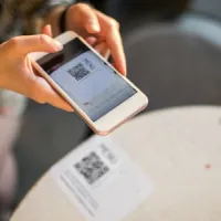 woman scanning QR code with smartphone