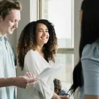 couple discusses paperwork with woman