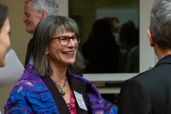 Woman smiling at IAALS 20th Birthday Party