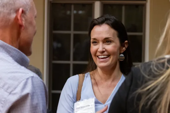 A woman smiling at the IAALS 20th Birthday Party