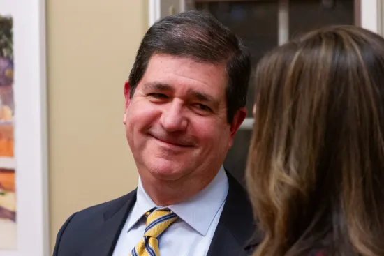 Man smiling at IAALS 20th Birthday Party