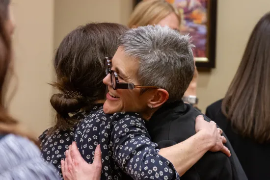 Two people hugging at IAALS 20th Birthday Party