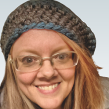 headshot of woman in hat