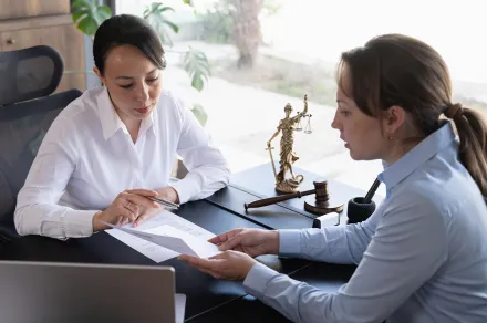Judge talking with colleague and reviewing paperwork