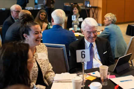 A group of people sitting at a table. 