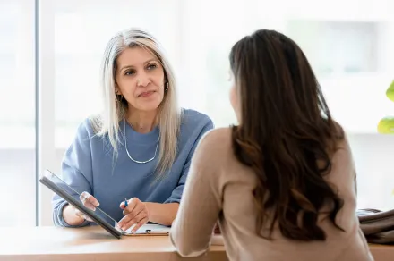 Lawyer showing her client a tablet