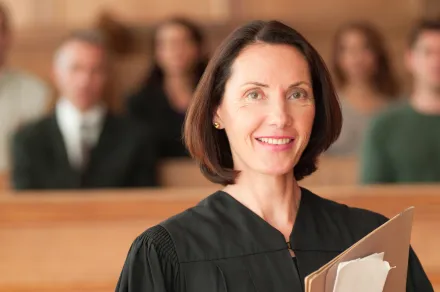 A judge holding papers in her courtroom