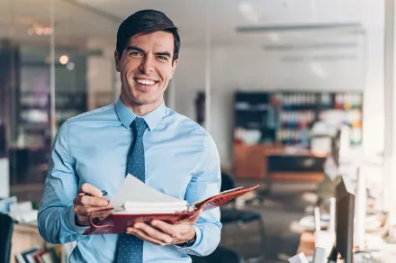 A man holding a notebook