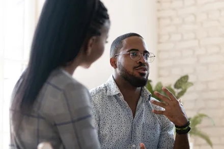 A man speaking with a small group of people