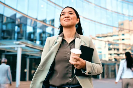 A woman walking confidently by a courthouse
