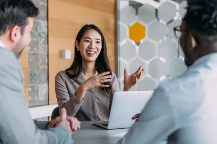A woman speaking with clients