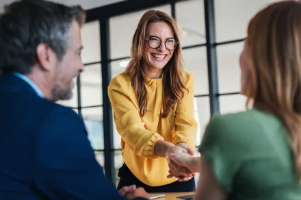 A lawyer shaking their client's hand