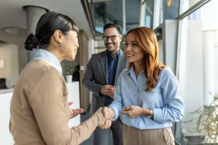 Three people shaking hands