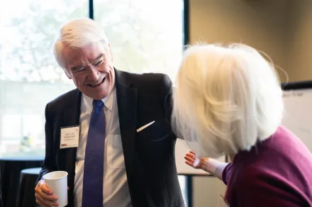 Chief Justice Nathan L. Hecht (Ret.) giving someone a hug