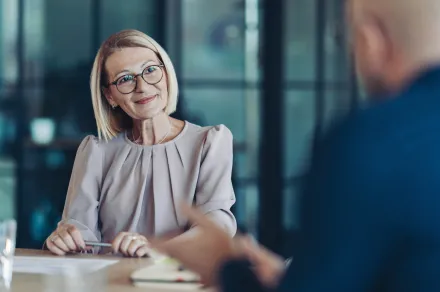 A woman listens to someone talking to her
