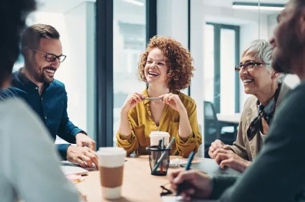A group of researchers laughing together. 