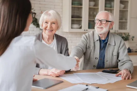 A lawyer helping an elderly couple with paperwork.