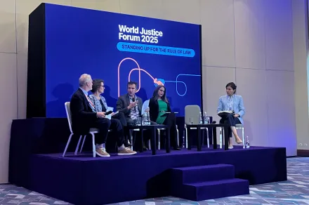 People talking onstage at a panel at the World Justice Forum 2025