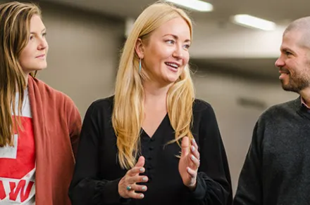 Anna Carpenter walking and speaking with students
