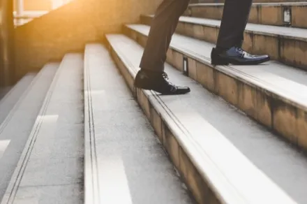 legs walking up concrete stairs