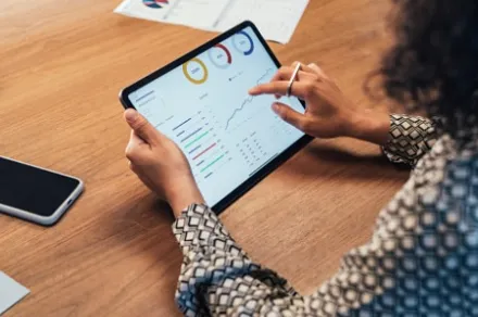 businesswoman analyzing data on tablet