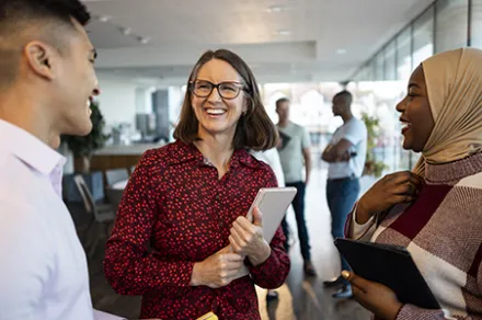 three people at work smiling