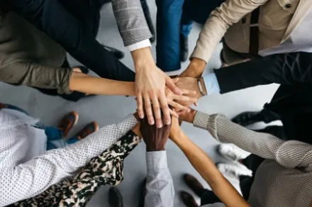 closeup of hands stacked together