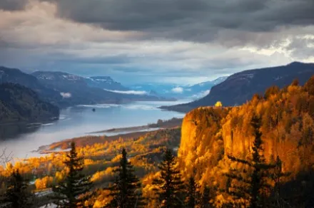 view of river between mountains covered with fall foliage