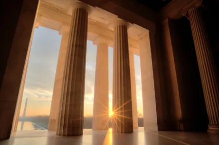 View from inside a courthouse looking out during a sunrise
