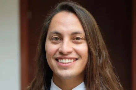 headshot of long-haired man