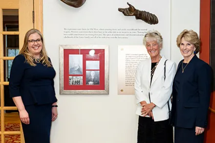 IAALS founders and CEO standing beside new tribute wall