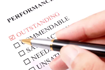 hand holding pen to do performance evaluation