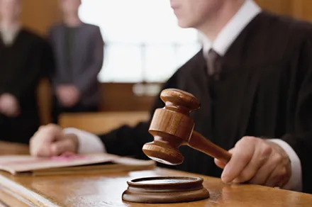 judge holding a gavel in a courtroom