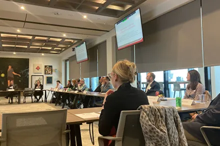 people in conference room watching presentation