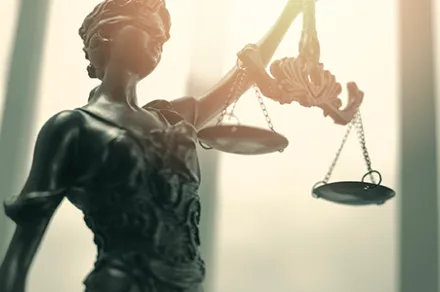 close up of metal lady justice holding scales