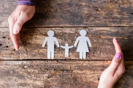 paper cutout of family on wood